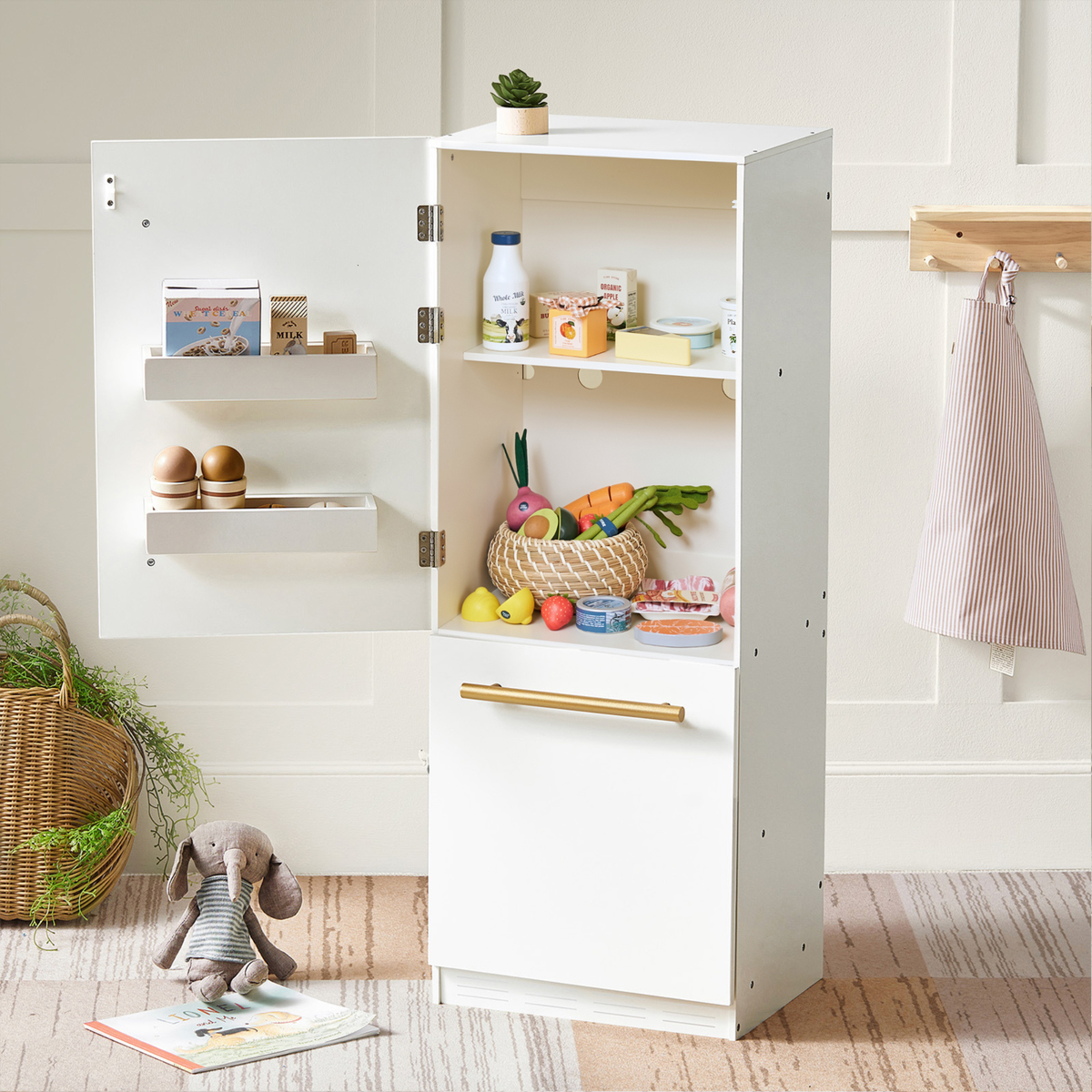 A white toy refrigerator with its door open, stocked with a Pretend Meat & Seafood Play Pack, including wooden vegetables, canned goods, and miniature cartons for kitchen play.