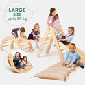 Five children play on the 5in1 Montessori Climbing Set, which features a triangle ladder, climbing arch/rocker, slide board/ramp, netting rope, and cushion—all in light wood—resting atop a cushioned mat. Text reads LARGE SIZE up to 80 kg. The background is white.
