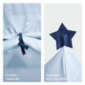 Light blue play tent curtains secured with tiebacks and a dark blue felt star decoration at the peak of the Starry Indoor Play Tent for Toddlers.