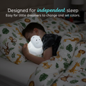 A child sleeps holding a glowing, hippo-shaped Honey the Hippo Silicone Night Light, designed to help little dreamers independently change and set soothing colors.