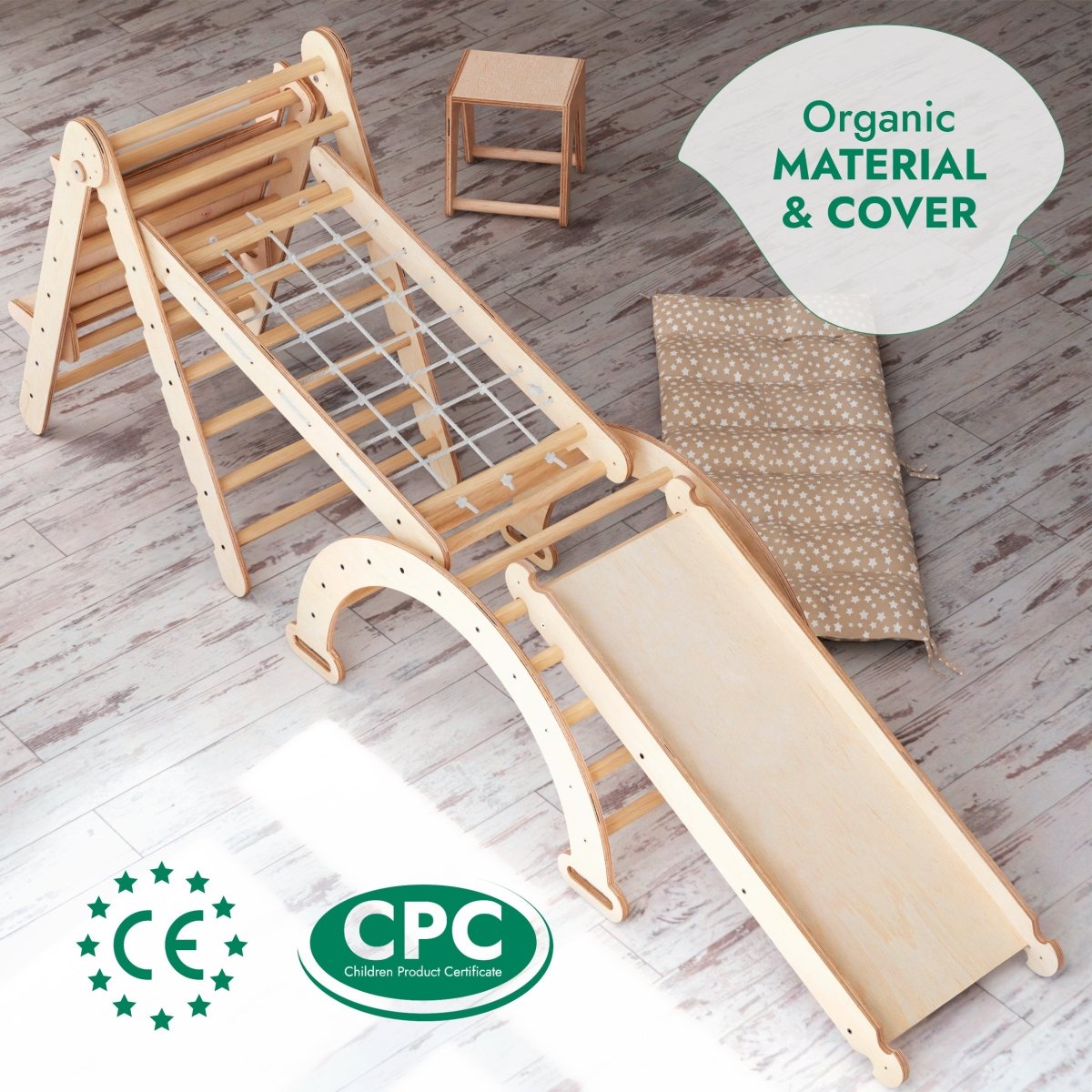 6in1 Montessori Climbing Set: Triangle Ladder, Arch/Rocker, Slide/Ramp, Net, Cushion, and Art Addition on a light wooden floor—ideal for holistic child development. This multifunctional play equipment is crafted from organic materials and certified with CE and CPC standards. A small stool and mat are also included.