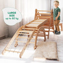 A young child stands on the 6in1 Montessori Climbing Set—which includes a triangle ladder, arch/rocker, slide/ramp, net, cushion, and art addition—with ramps and a padded mat nearby, showcasing the benefits of holistic child development. A speech bubble reads: LARGE SIZE up to 80 kg.