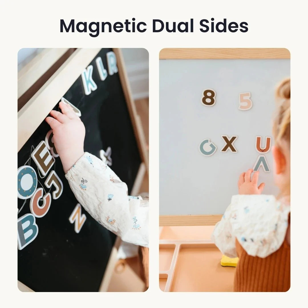 A child uses magnetic letters and numbers on the Tiny Land® Magnitales Easel for Kids, which features dual sides—one black and one white—showcasing its magnetic functionality. The top text reads: Magnetic Dual Sides.