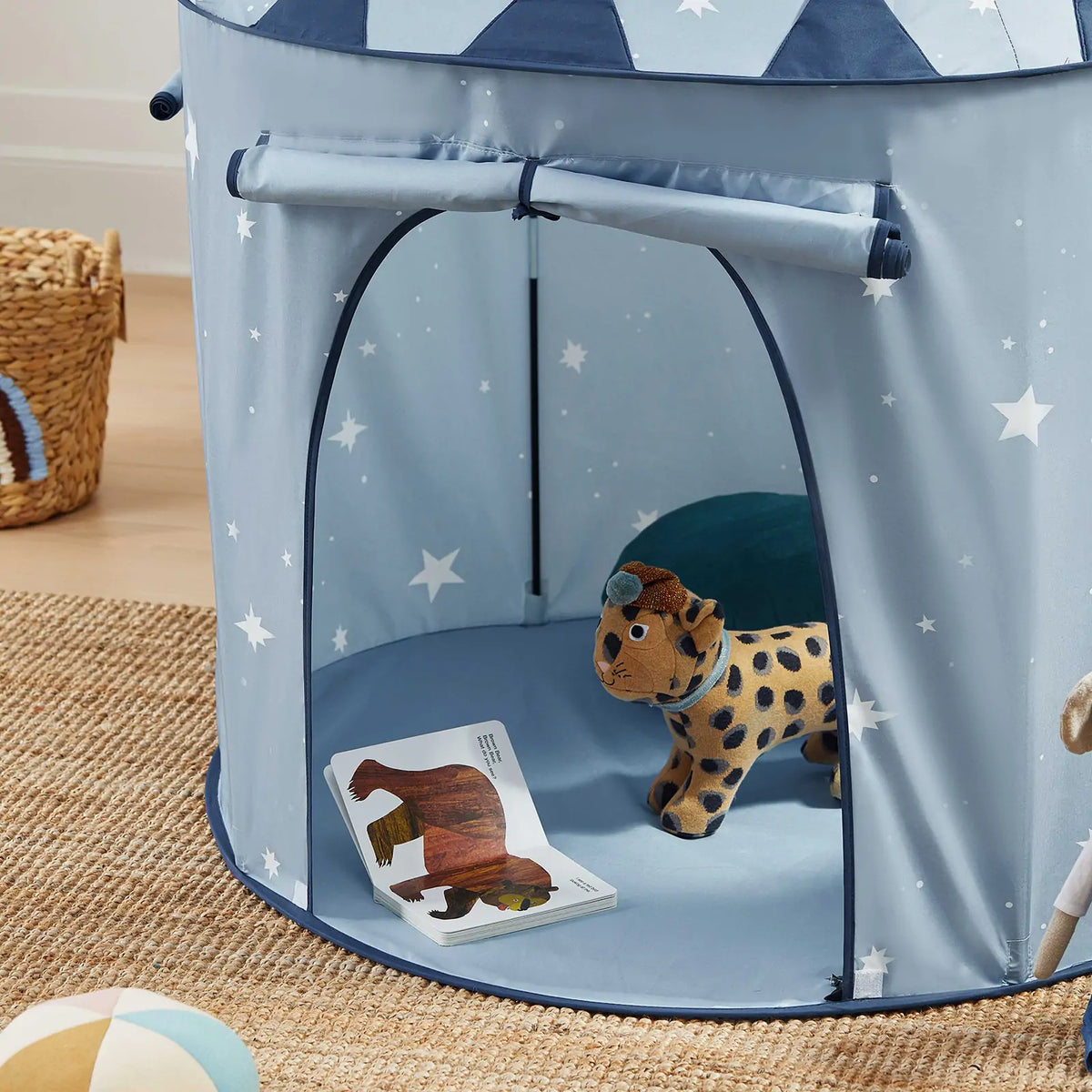 Starry Indoor Play Tent for Toddlers in light blue with a white star pattern, containing a plush leopard toy and an open children’s book.