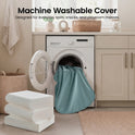 A GentleSnug Flip-Open Kids Sofa & Nap Mat with its blue cover draped out of the open washing machine door, with text above reading Machine Washable Cover: Designed for everyday spills, snacks, and playroom messes.