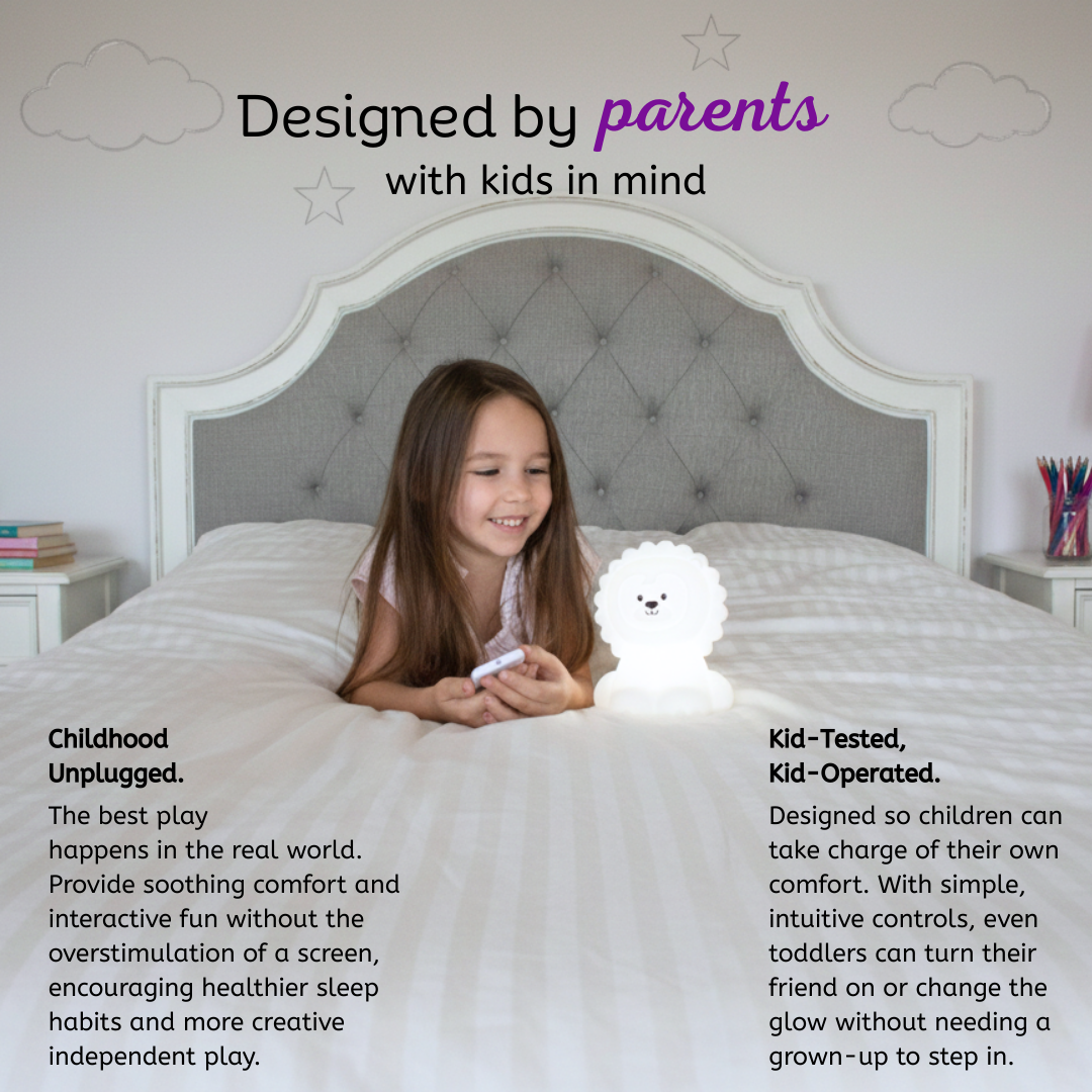 A young girl sits on a bed playing with a color-changing, lion-shaped Luther the Lion Silicone Night Light.