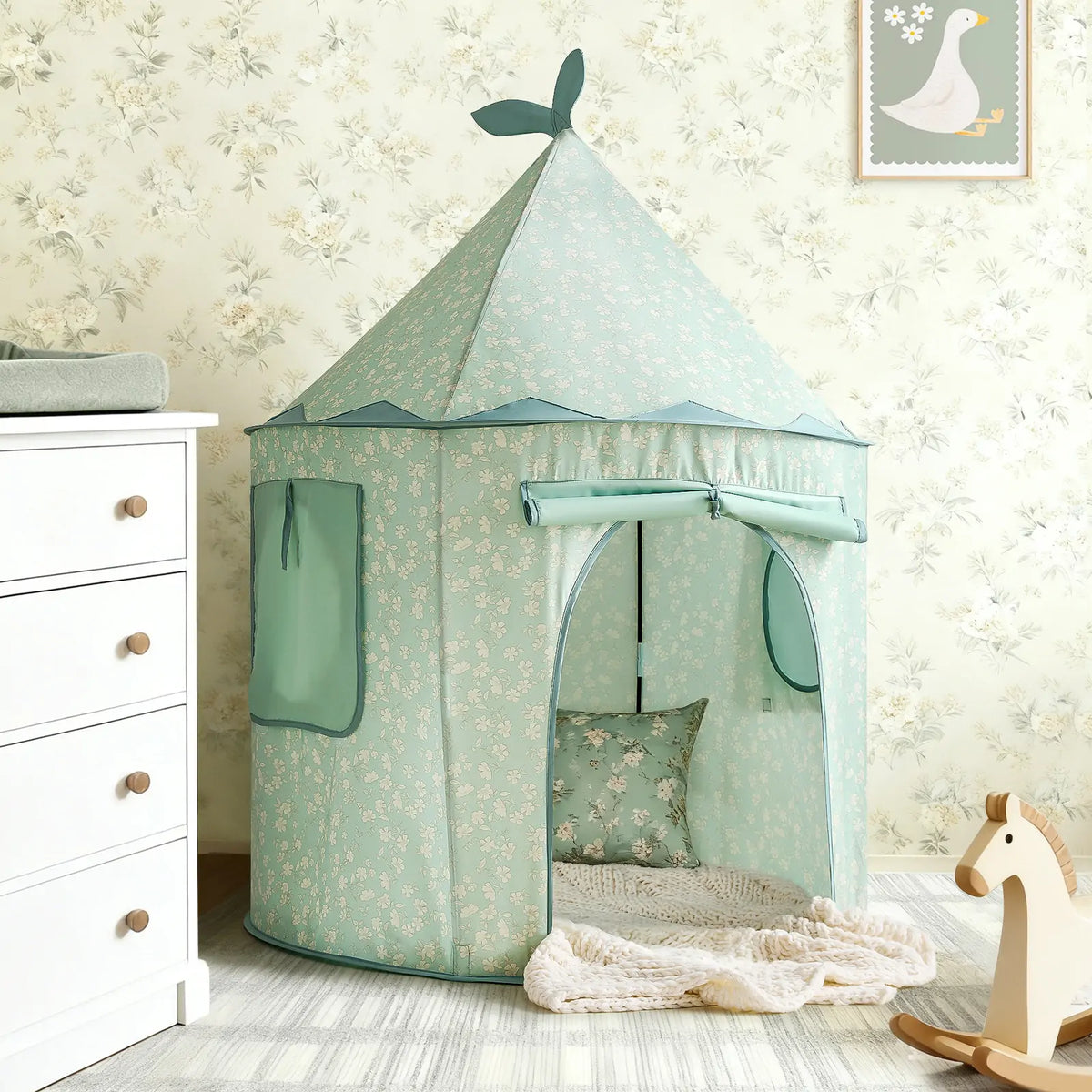 Starry Indoor Play Tent for Toddlers in mint green with a floral pattern, featuring a conical top, roll-up door, and an interior pillow and blanket.