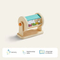 The Tiny Land® Montessori Toys for Newborns (4–6 Months) feature a wooden rotating drum with colorful beads on a base—ideal for fine motor skills. Icons and text below highlight: Sensory, Relationship Skills, and Language & Literacy.