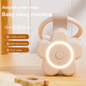 The Portable Newborn Baby Sleeping Gadgets White Noise Device glows with a circular night light. Features include natural white noise, lullabies, timer mode, and teething toy. Shown on a light wooden surface.