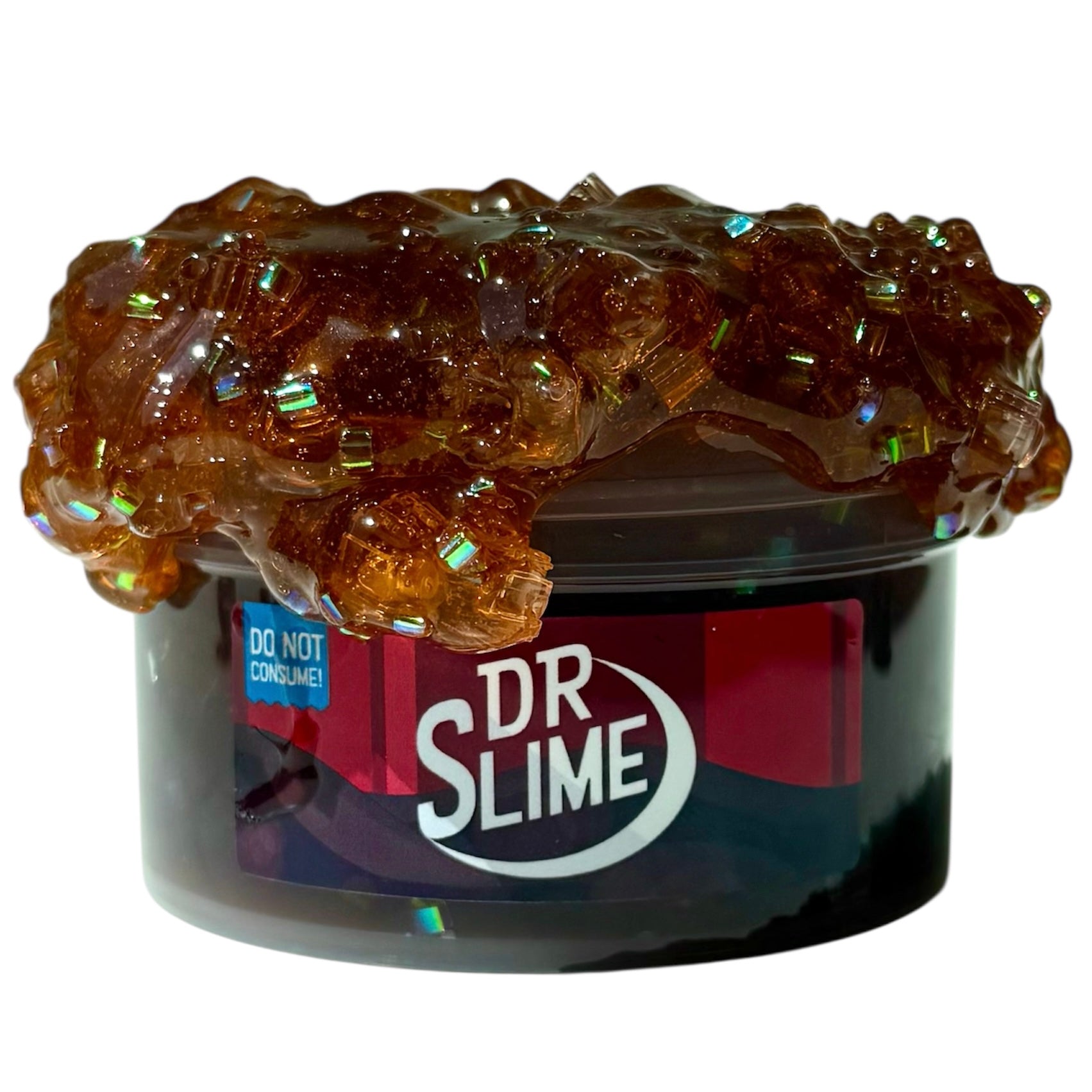 A 7 oz tub labeled Dr Slime Dr Pepper Scented Block Bead Bingsu Slime overflows with glossy, amber slime, shiny beads, and blocks. A warning label says: Do Not Consume. The coated texture delivers a long-lasting Dr Pepper aroma.