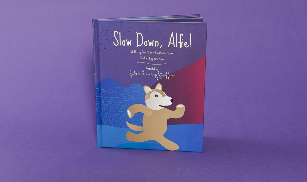 The cover of the picture book Slow Down, Alfie! features an illustration of a running dog, offering a story about mindfulness and calming tactics for kids.