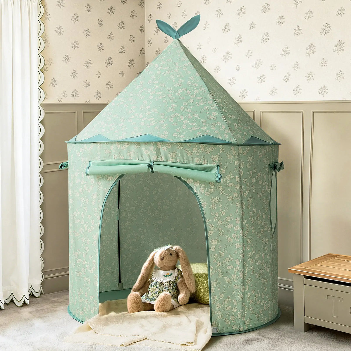 Green conical Starry Indoor Play Tent for toddlers featuring a white floral pattern with a plush rabbit toy sitting inside.