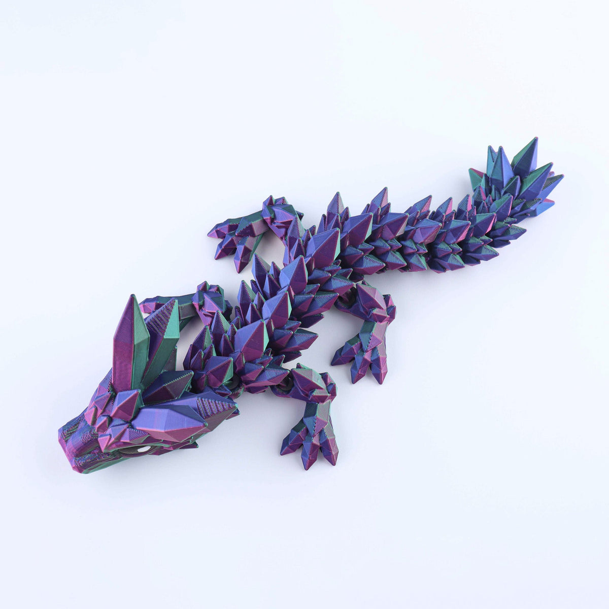 A poseable Crystal Baby Dragon – Poseable Fidget Toy featuring an iridescent, crystalline body.