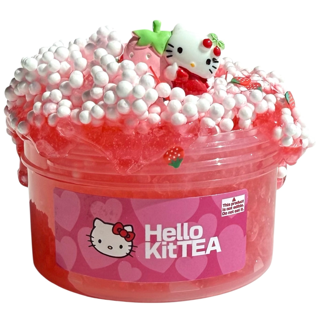 Hello Kittea Silica Floam Slime (7oz) features pink, heart-labeled slime with white foam beads, strawberry slices, and a Hello Kitty charm holding a green leaf—plus a Hawaiian Punch scent for a cute, crunchy sensory treat.