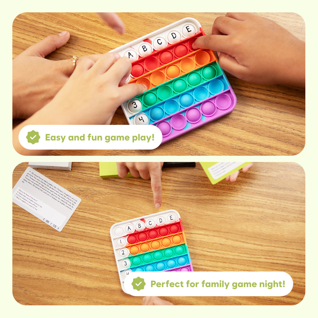 Hands interact with a square, rainbow-colored push-popper toy from the Comprehension Codes Reading Game, featuring letters A through E, numbers 1 through 4, and reading comprehension cards to help kids make inferences.
