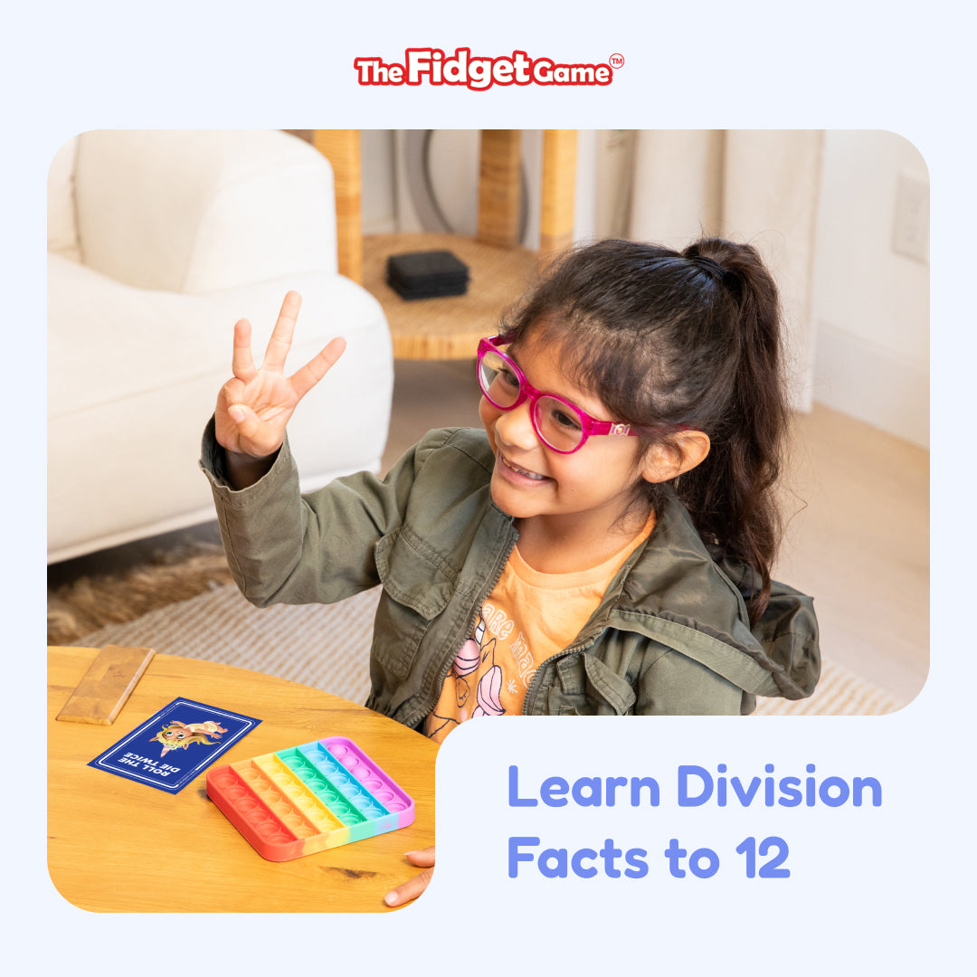 A young girl wearing glasses holds up three fingers while sitting at a table with Division Card Pack – CHOOSE Act Edition flash cards, a rectangular pop-it toy, and the text Learn Division Facts to 12.