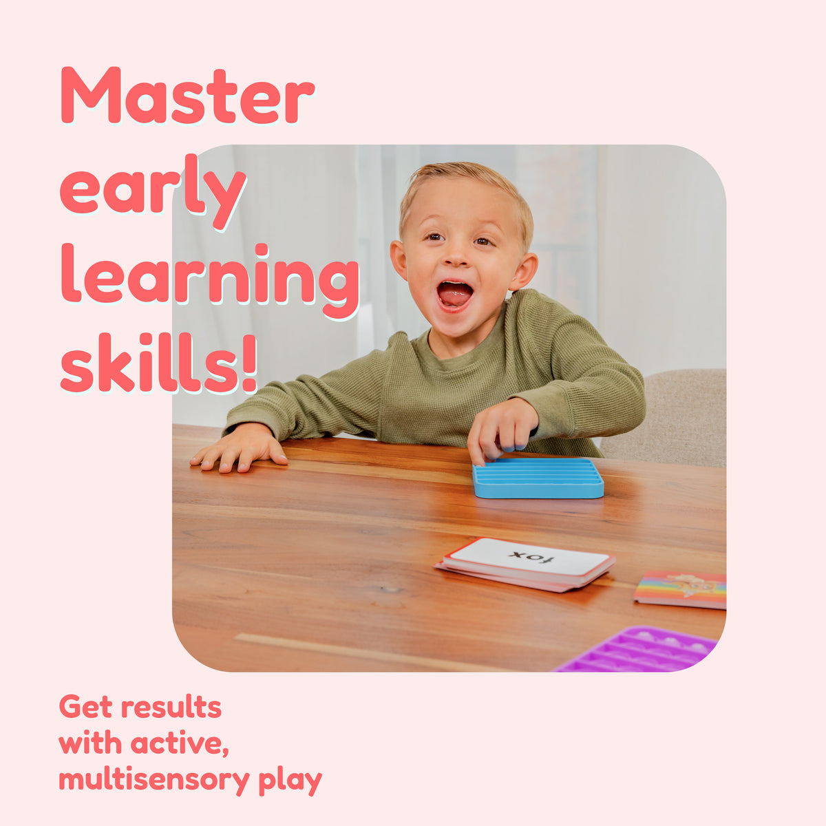 A young boy with an excited expression sits at a table using blue silicone sensory toys and word cards from the First Words Game Bundle for preschool reading games, featuring the text Master early learning skills! and Get results with active, multisensory play.