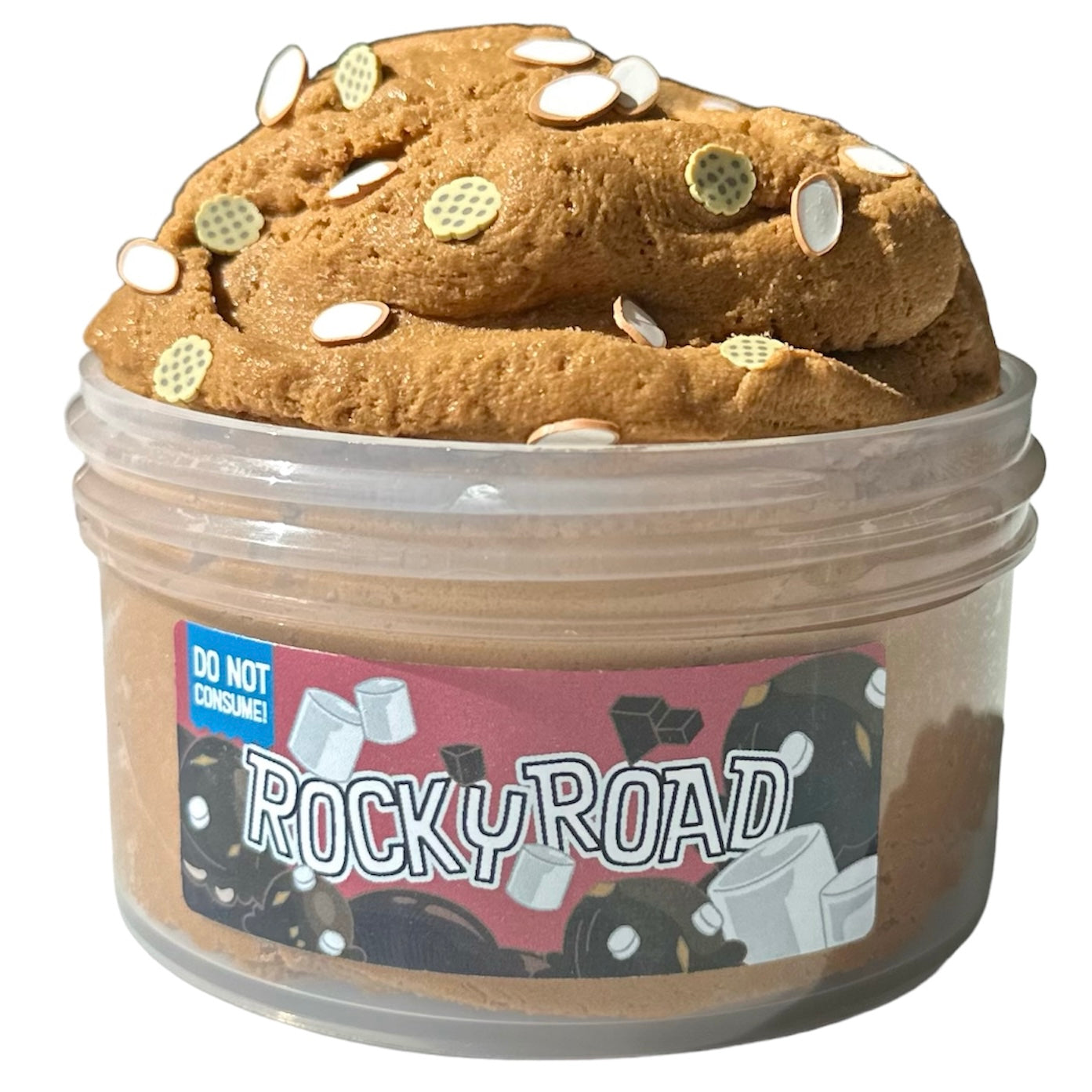 Rocky Road Cloud Cream With Almond And Cookies Sprinkles Scent is a 7 oz brown, fluffy slime with white and yellow clay pieces. Dessert-inspired, it hydrates skin with a rich aroma. A blue label warns: Do not consume.