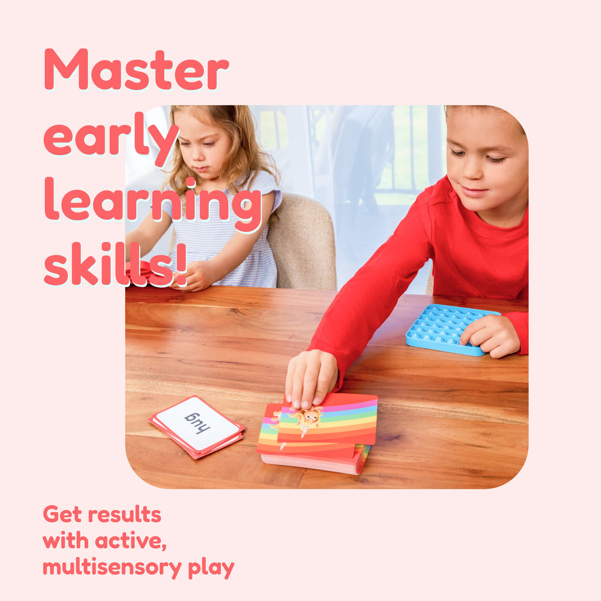 Two children play with phonics flashcards and a blue sensory toy from the Growing Reader Game Bundle.