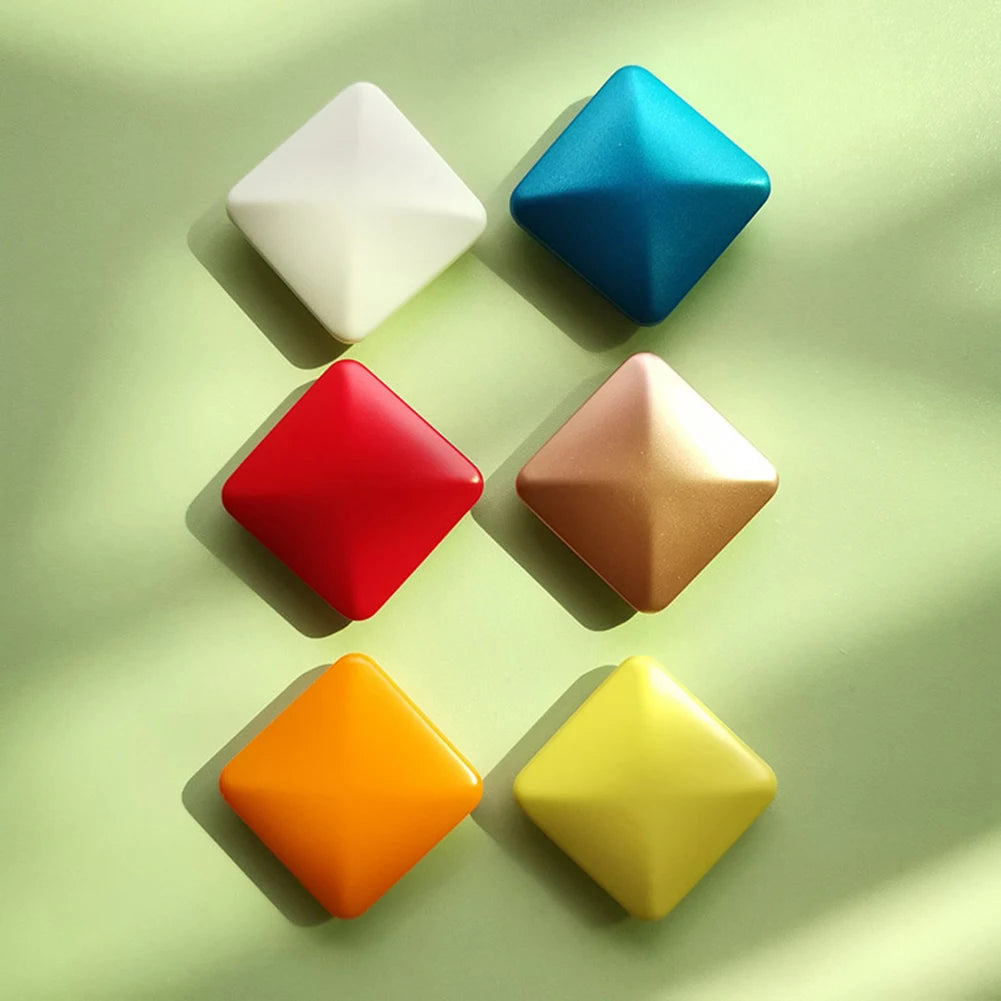 Six VKTECH Plastic Desk Toy Kinetic Skill Fidget Spinners are arranged in two columns on a light green surface in white, red, orange (left) and blue, gold, yellow (right). Made in Mainland China.