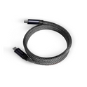 The Magnetic Charging Cable, a black and white braided USB-C to USB-C cable with Power Delivery and sleek black connectors, is coiled in a circle on a white background.