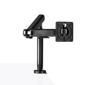 The Single Monitor Arm, in black, is mounted on the edge of a white desk for ergonomic setup. It has adjustable joints and a mounting plate for your monitor. The plain white background highlights the workspace.