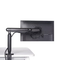 The Single Monitor Arm, in black, is mounted on a white desk and supports a flat-screen monitor. Its sleek design keeps cables organized for an ergonomic workspace, all set against a plain white background.