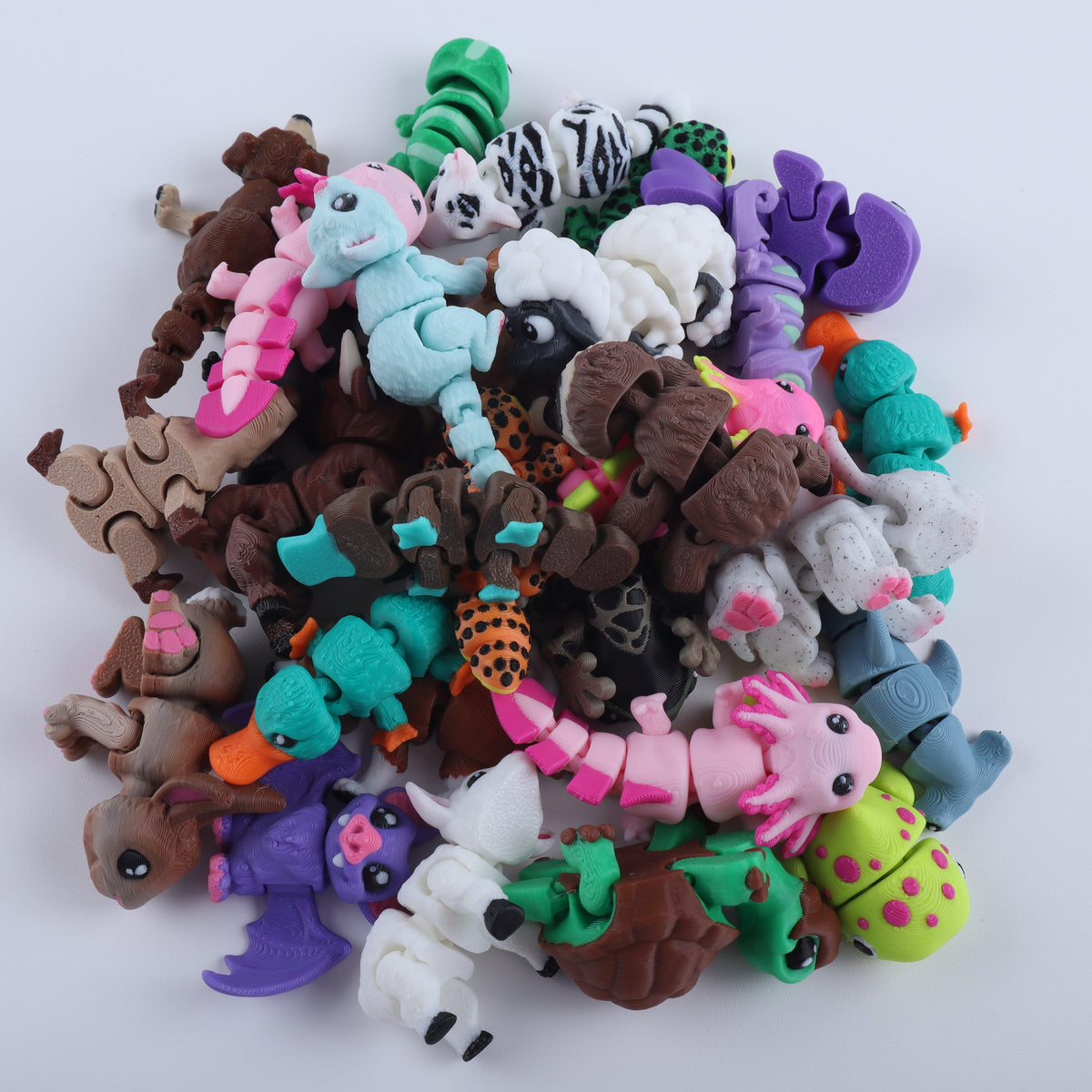 A pile of colorful, articulated Mini Fidget Creatures – Surprise Pack toys in the shape of animals.