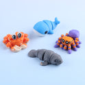 Mini Fidget Creatures – Surprise Pack featuring an orange crab, a blue whale, a purple and orange spider, and a grey manatee.