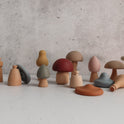 Mushroom Mix & Match Sorting Toy (24 pc) featuring a collection of wooden and silicone mushroom-shaped pieces in various colors and shapes, designed to help develop fine motor skills.