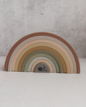 Silicone Rainbow Stacking Toy (10 pc) featuring ten arched pieces in muted earth tones.