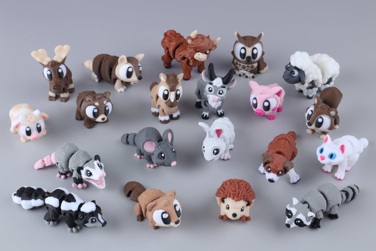 Twenty Mini Forest & Farm Animal Fidgets – 20 Pack, including an owl, sheep, rabbit, hedgehog, skunk, and raccoon, are arranged as articulated 3D-printed pocket desk pets on a gray surface.
