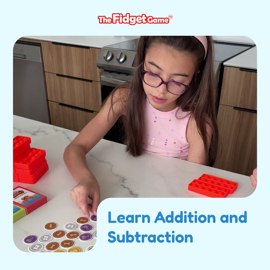 A child wearing glasses sits at a kitchen counter playing the Math Ahoy! Addition & Subtraction Game with circular number tokens and red silicone popping toys.