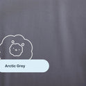A close-up of the Forever Chill Bamboo Sheets in a solid arctic grey shade, expertly crafted from organic bamboo viscose for exceptional softness and breathability. The sheet features a charming line drawing of a lion and a label reading “Arctic Grey” in a light blue rounded rectangle—perfect for anyone searching for bamboo cooling sheets that blend comfort with an adorable touch.