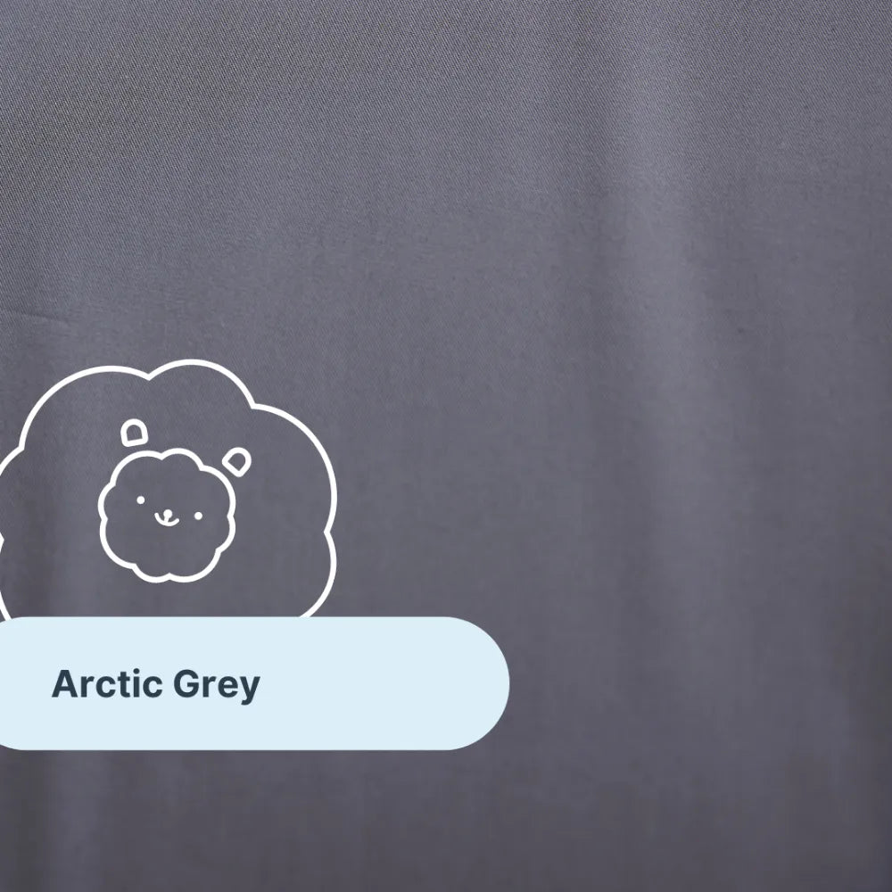 A close-up of the Forever Chill Bamboo Sheets in a solid arctic grey shade, expertly crafted from organic bamboo viscose for exceptional softness and breathability. The sheet features a charming line drawing of a lion and a label reading “Arctic Grey” in a light blue rounded rectangle—perfect for anyone searching for bamboo cooling sheets that blend comfort with an adorable touch.