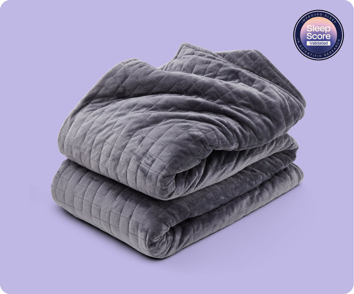 Folded grey Gravity Original Weighted Blanket (10–25 lb) with a breathable cover, a quilted grid pattern, and a Sleep Score Validated circular badge in the corner.