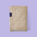 Folded tan Gravity Original Weighted Blanket (10–25 lb) with a square-stitched pattern, a breathable cover, and a small dark tag on the side.