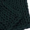 Close-up of the Knit Weighted Blanket in dark green, featuring thick, braided yarn strands woven together to create a beautifully textured, chunky knit pattern.