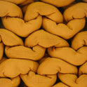 Close-up of thick, mustard-yellow strands woven in a chunky braid highlights the texture and stitching details of the Knit Weighted Blanket.