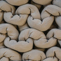 Close-up of thick beige strands woven in a chunky, braided pattern, creating a textured and interlocked surface on the Knit Weighted Blanket.