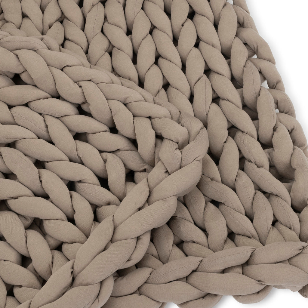 Close-up of the Knit Weighted Blanket in light brown/taupe, showcasing thick, soft braided yarn and a large, intricate knit pattern for cozy, breathable comfort.