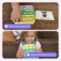 Two children use Popplers: Daily Routines & Feelings Toddler Game, with one pressing a button on a multi-colored emoji tray next to a feelings card, while the other holds a tray featuring daily routine icons for emotion recognition.