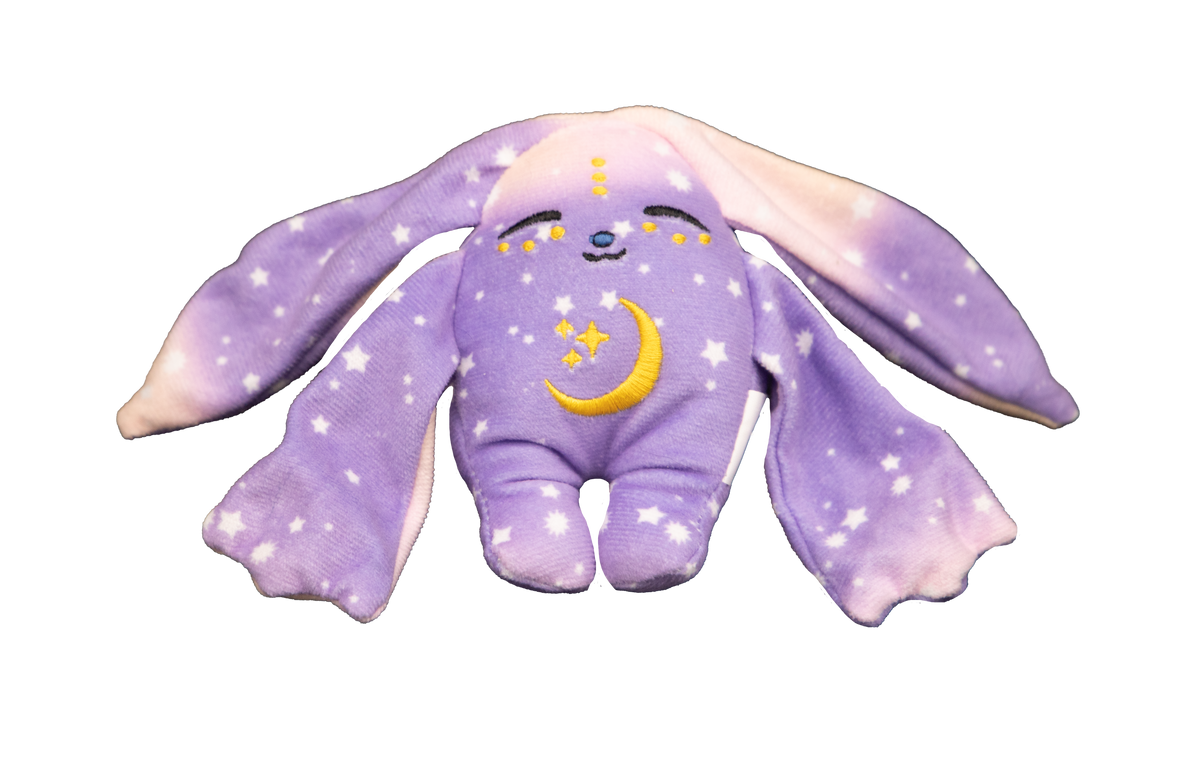 A purple Polli Mini Wrist Hugger – Magnetic Sensory Plush featuring long ears, a star-and-moon pattern, a sleeping expression, and a yellow crescent moon embroidery on its chest.