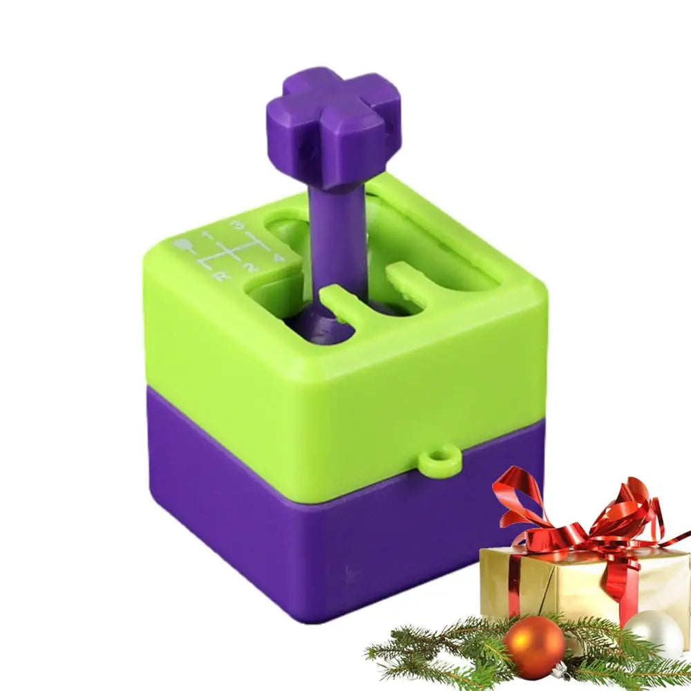 A green Manual Gear Shifter Keychain 3D Printed Fidget Toy sits by a decorated gift box with a red bow, ornaments, and pine branches—designed to be chemical-free for safe fun at the office, school, or outdoors.