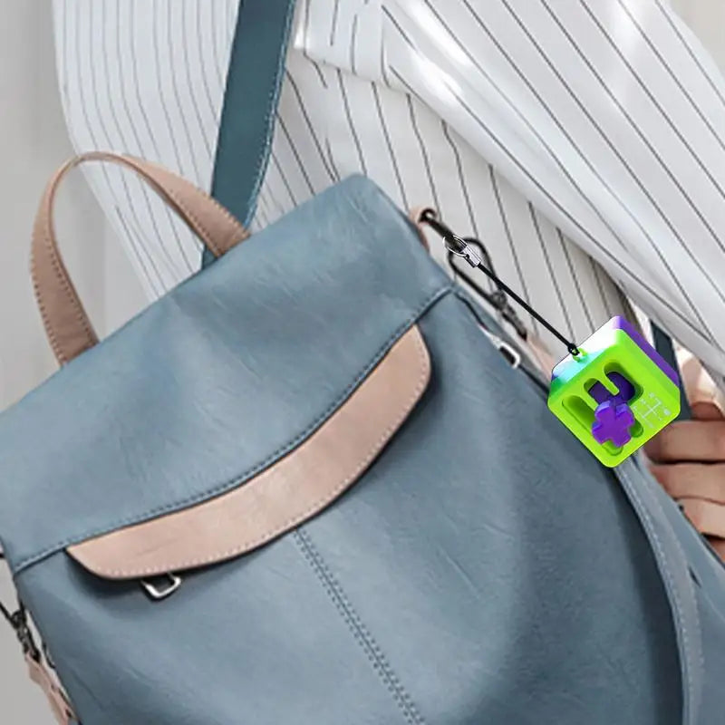 A person in a white pinstriped shirt carries a MINOCOOL light blue backpack with tan accents, featuring a Manual Gear Shifter Keychain 3D Printed Fidget Toy attached to the bag.