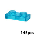 A 1x2 transparent blue brick from the MOC Transparent Bulk Brick Set—compatible with Lego—is shown on a white background, ideal for adding to your clear building block collection. 145pcs is displayed in black in the bottom right corner.