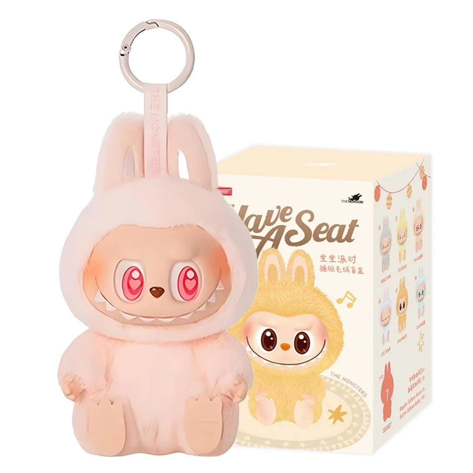 The Cute Labubu The Monsters Box Toy Sweetheart Vinyl Doll in Style C (with box) is a kawaii pink plush keychain featuring bunny ears, big pink eyes, and a toothy smile—perfect as a backpack pendant or collectible gift for fans.