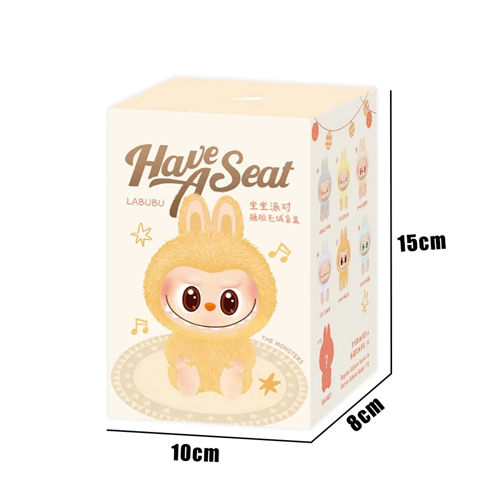 The MINISO Cute Labubu The Monsters Box Toy features a sweetheart vinyl doll in a fluffy yellow bunny suit with Have A Seat text. Box (15×10×8cm) displays colorful Labubu images, musical notes, and doubles as a kawaii keychain gift or backpack pendant.