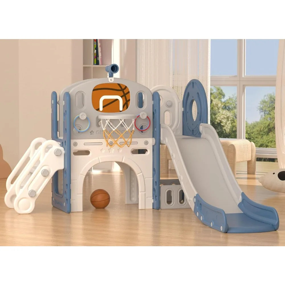 The 8 In 1 Toddler Slide Set With Basketball Hoop For Kids features a small blue-and-white slide, climbing structure, basketball hoop with net, and basketball on the floor, set up in a bright room with large windows.