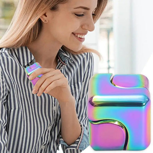 A woman in a striped shirt smiles while holding the Infinity Gear Cube Spinner Antistress Toy. A close-up of the colorful fidget block cube is also shown in the foreground.